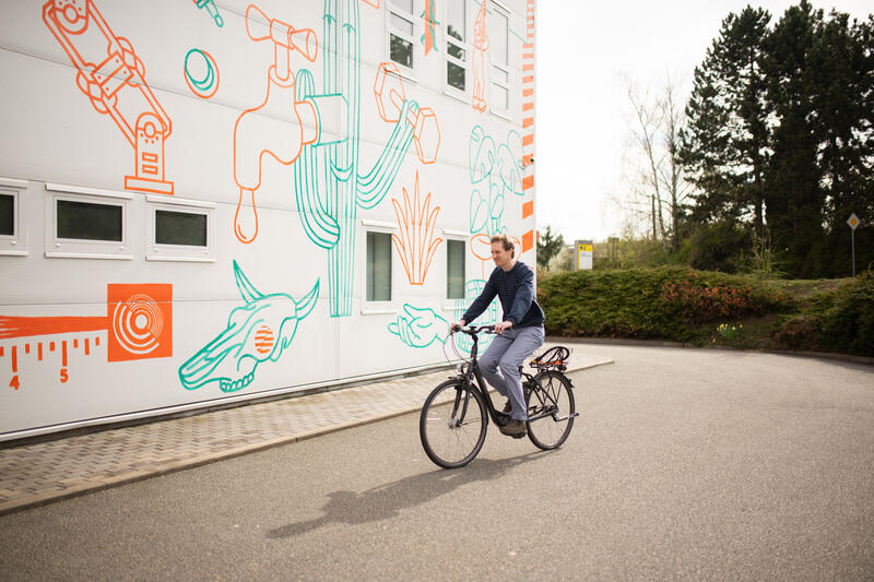 Tomáš riding a bike by the Y Soft office building
